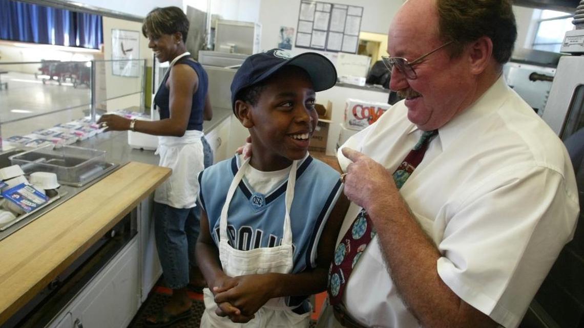 Bill Griffin jokes with Jameal York at West Fresno Elementary School in 2003 when Griffin was serving as administrator of the then-state-run district. Griffin, known for his influence on the Valley school sports scene, died in February. A memorial service is planned for Saturday, April 16.