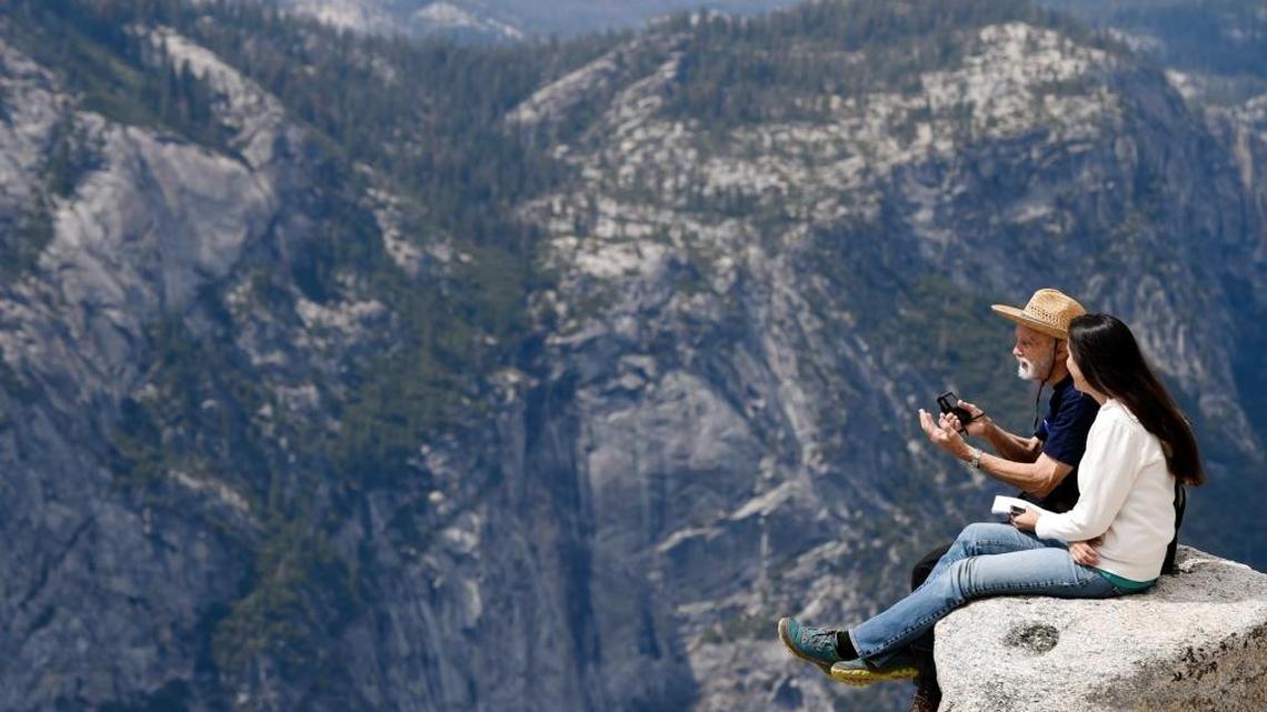 Fresno Bee columnist Carmen George, right, sits with George Whitmore, 85, at Taft Point in Yosemite National Park during a May 2016 interview.