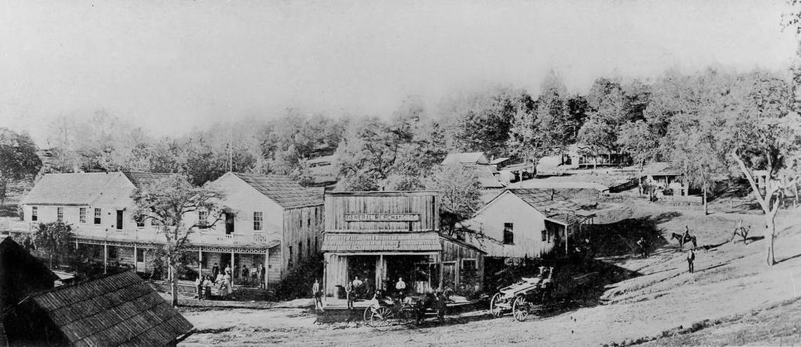 The Madera County town of Grub Gulch on the old stage road (Road 600), south of Ahwahnee, as it looked in the 1890s. At left is Thomas Hotel, where President Theodore Roosevelt stopped in 1903. At right is Abe Taylor’s general store and Charlie Lyons’ saloon.