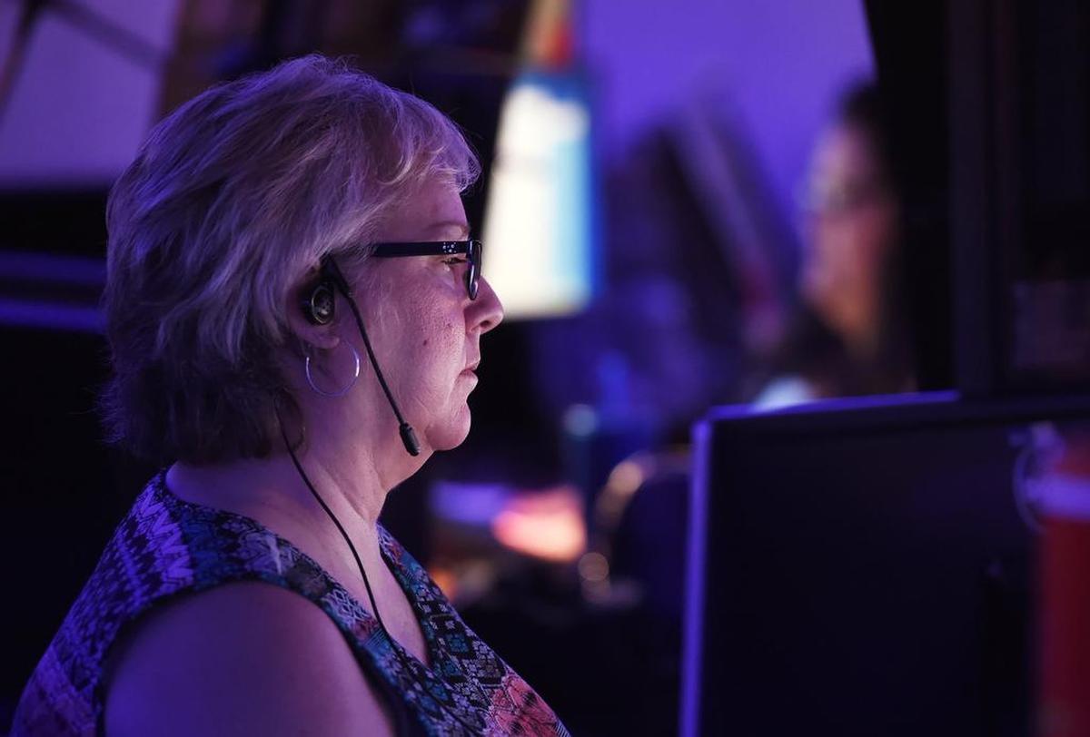 Emergency services dispatcher Lorin Moore, left, monitors her screens at the Fresno Police Department’s Dispatch Center Monday, July 30, 2018 in Fresno.