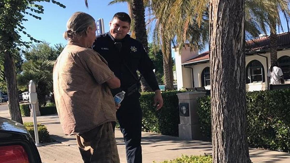 Fresno police Downtown Patrol Unit Officer Eric Hull with Robert Snider, 65, who had been homeless in Fresno until Wednesday when police pooled donations to buy Snider a train ticket back to Sacramento where he has family.