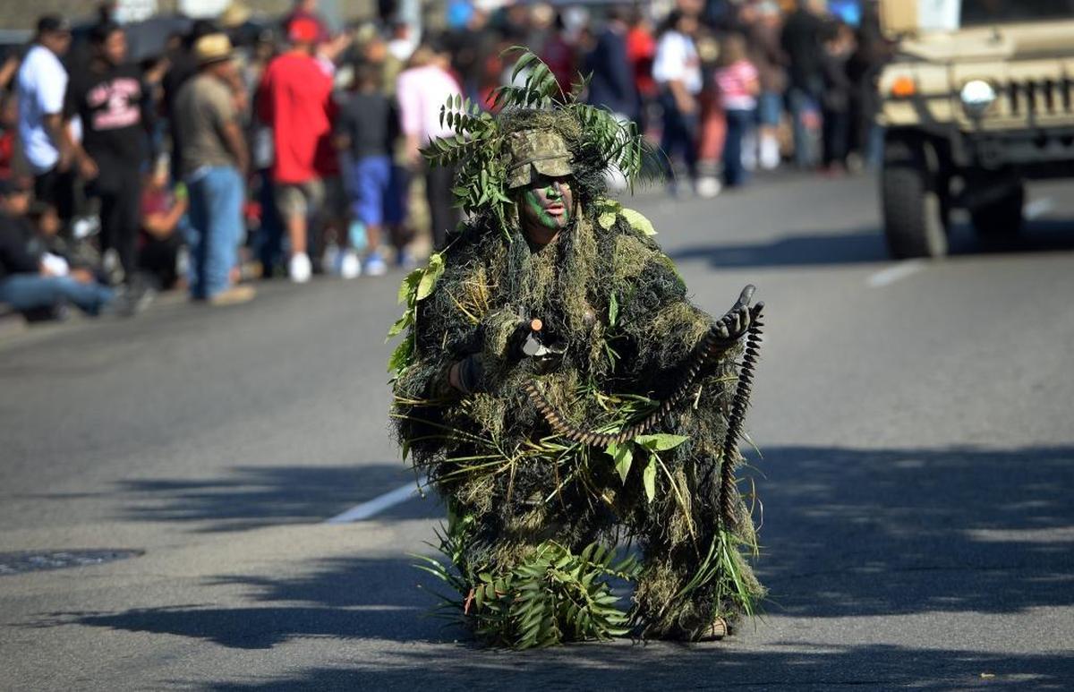 A soldier in sniper camouflage participates in the annual Veterans Day Parade in downtown Fresno on Saturday, Nov. 11, 2017.