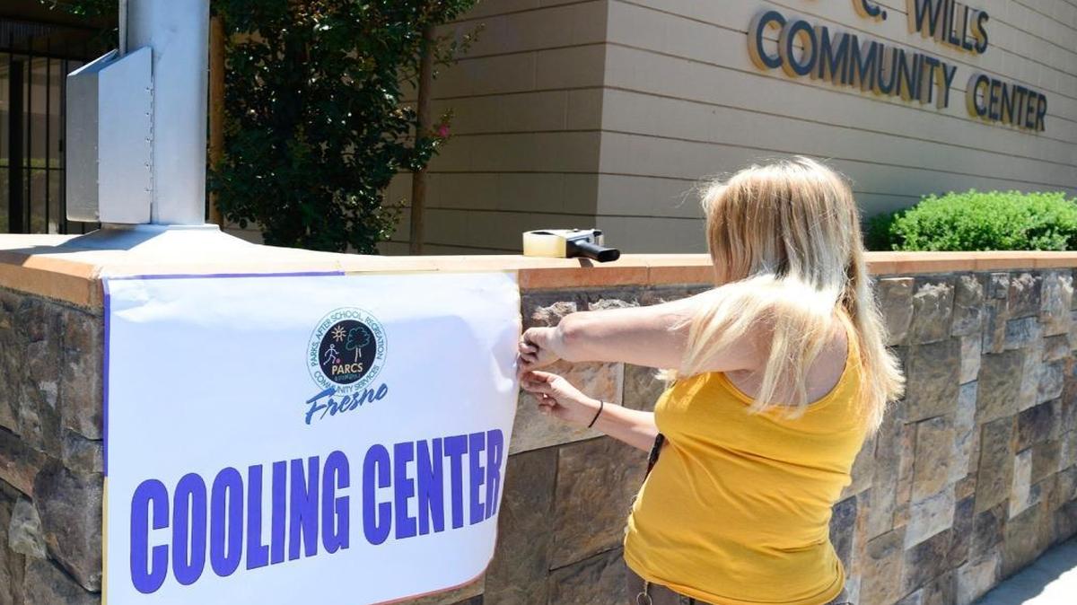 In a June 2015 file photo, Wendi Danyluk of Fresno’s recreation department puts up a sign at the Ted C. Wills Community Center. Because of hot weather, the city will open its cooling centers for the first time this year on June 2, 2016.