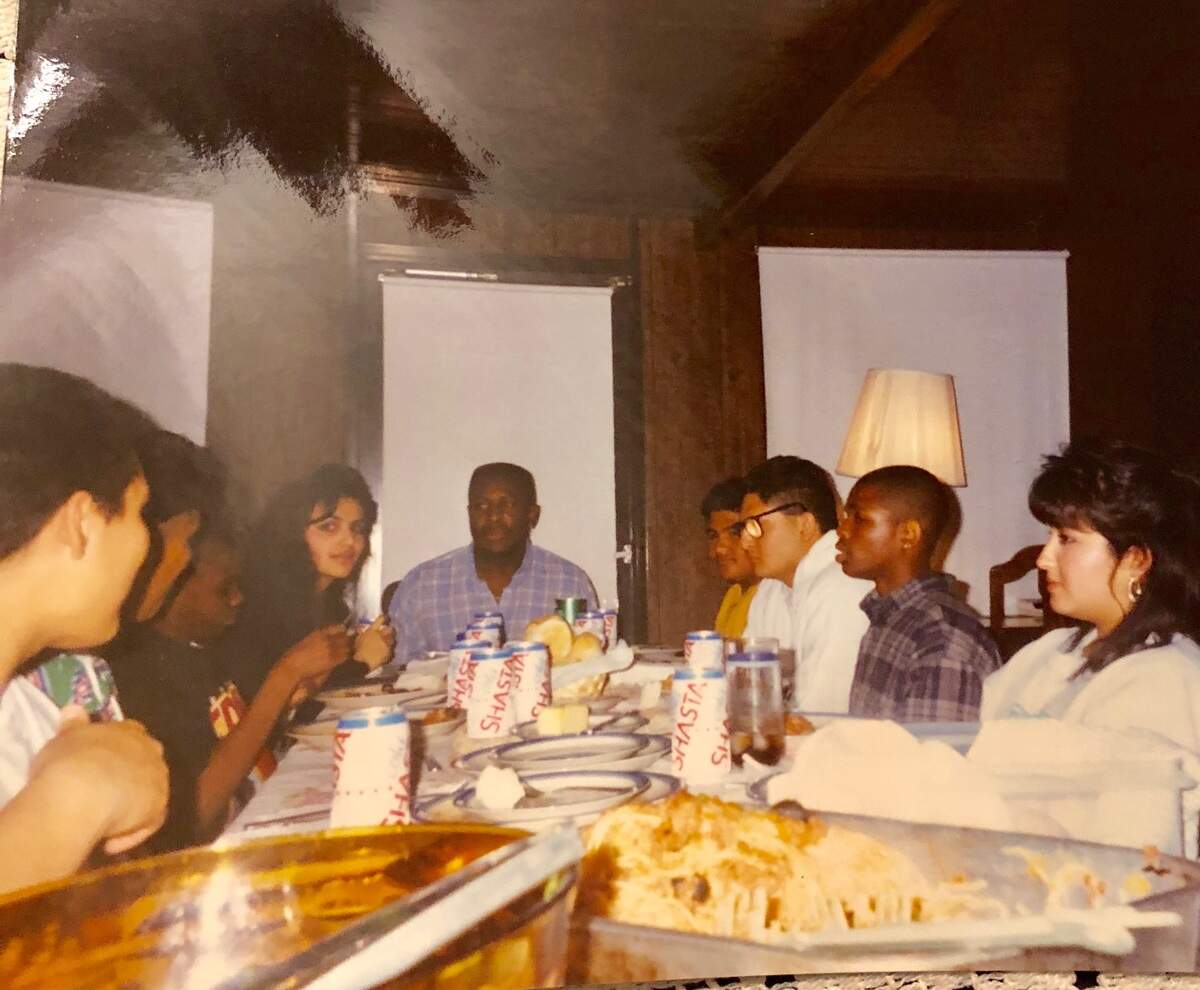 In this photograph from the 1990s, Terance Frazier, center, dines with the Franco family at their home in Fresno.