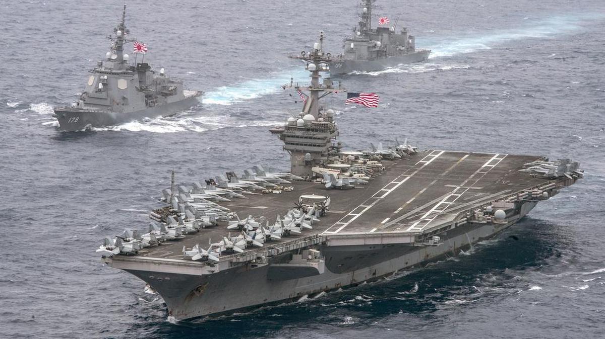In an April 26, 2017 photo released by the U.S. Navy, aircraft carrier USS Carl Vinson sails the Philippine Sea escorted by Japanese destroyers. The aircraft supercarrier was headed toward the Korean Peninsula for an exercise with South Korea. About 700 sailors from Naval Air Station Lemoore are aboard the Vinson.