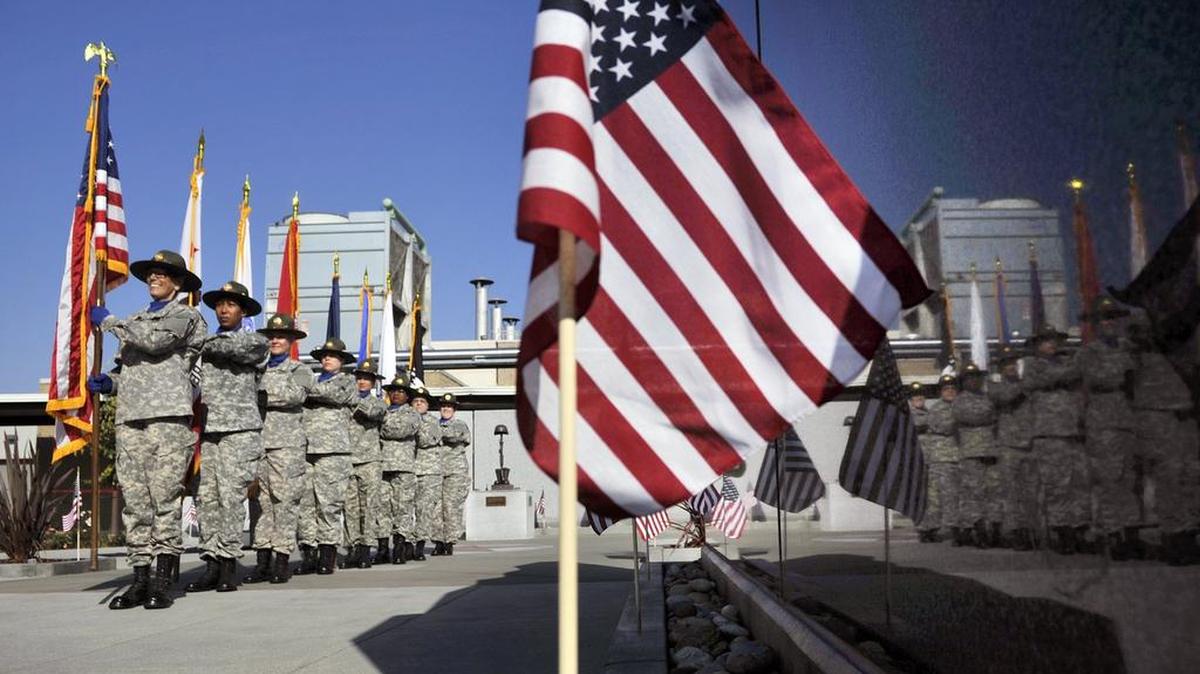 The VA Women’s Color Guard lines up for a photograph at the start of the inaugural ceremony for the Walk of Honor at VA Central California Health Care System hospital Saturday in Fresno..