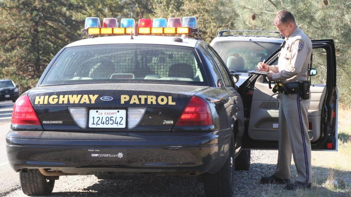 California Highway Patrol Officer Raul Gonzalez cites a driver on Highway 49 for using a cellphone on Oct. 22. CHP Officer Traci Gallian writes about a typical day in the life of a CHP officer.
