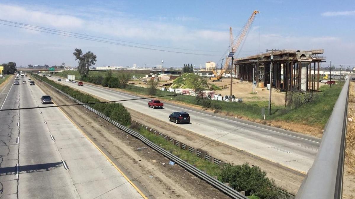 Traffic rolls along Highway 99 under Cedar Avenue at the southern end of Fresno on Wednesday while construction crews for the California High-Speed Rail Authority build a large viaduct, or elevated railway, for the state’s future bullet-train project. The viaduct will span Highway 99 and Cedar and North avenues.