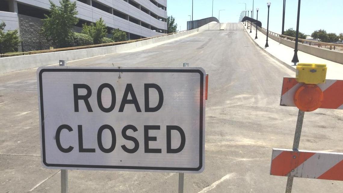 The eastern approach to the new Tuolumne Street bridge remains closed to traffic in downtown Fresno. Contractors are being required to make repairs to the concrete surface of the bridge deck to make it smooth enough for vehicles once the bridge opens.