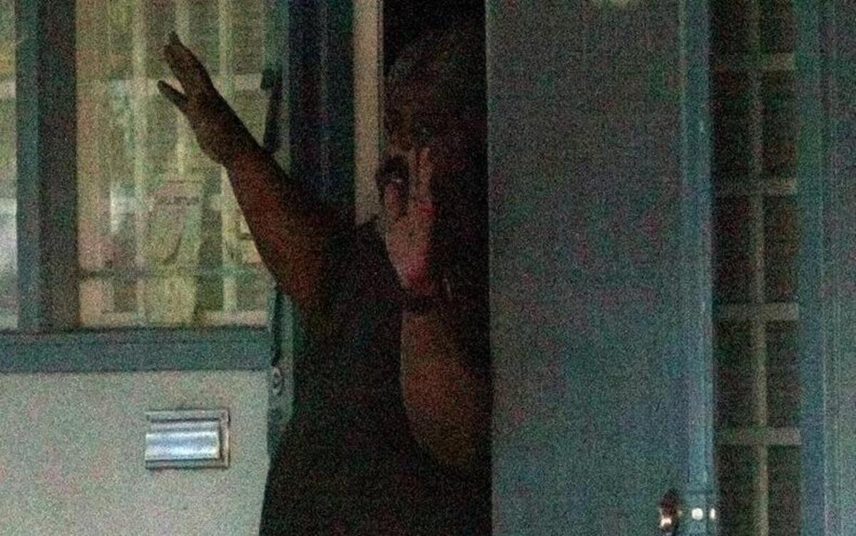 Marcus Wesson emerges with his hands up as he surrenders to Fresno police on March 12, 2004.