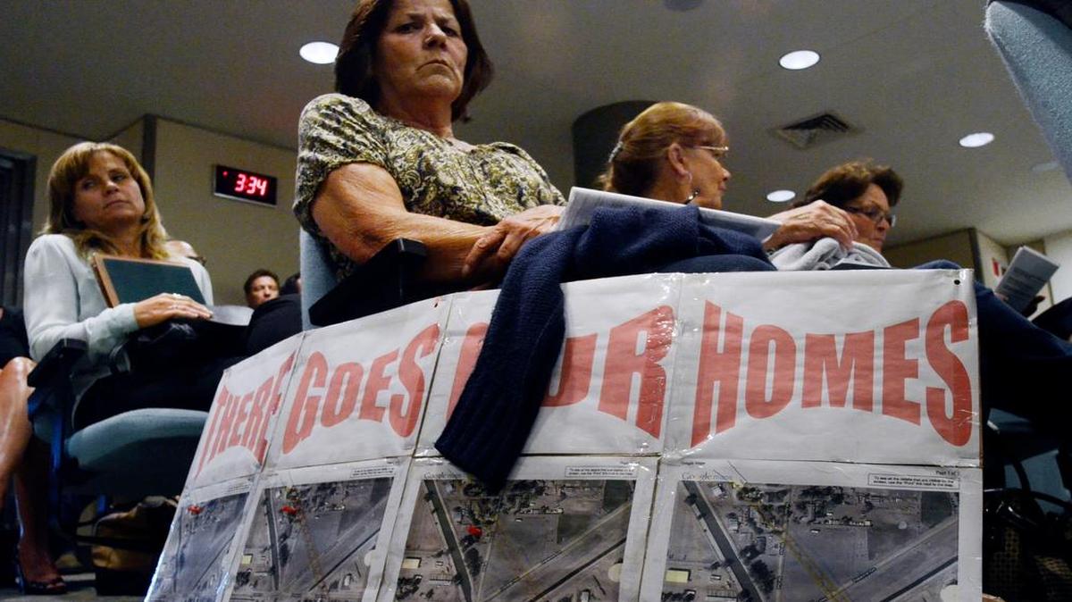 
At a May 2014 California High-Speed Rail Authority meeting in Fresno, Charlene Hook of Corcoran and two of her sisters brought a sign protesting the possible loss of their homes to the bullet-train route. Since March, the state has adopted 62 resolutions authorizing the use of eminent domain to acquire more than 260 acres of property in Kings County.
