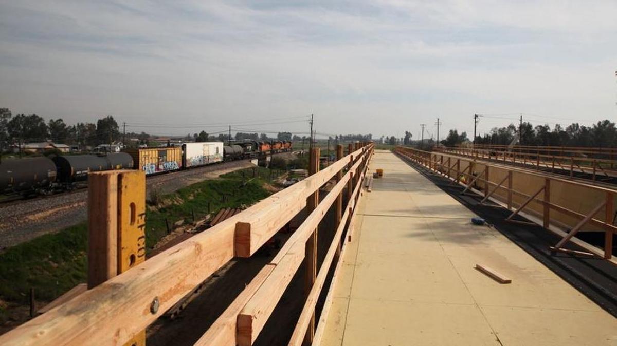 Work continues on a high-speed rail viaduct, or elevated bridge, over the Fresno River next to the BNSF Railway freight trail tracks east of Madera. It is part of a 29-mile, $1 billion construction contract. A $154 million change order to the contract will extend work north of this site to about Avenue 19.