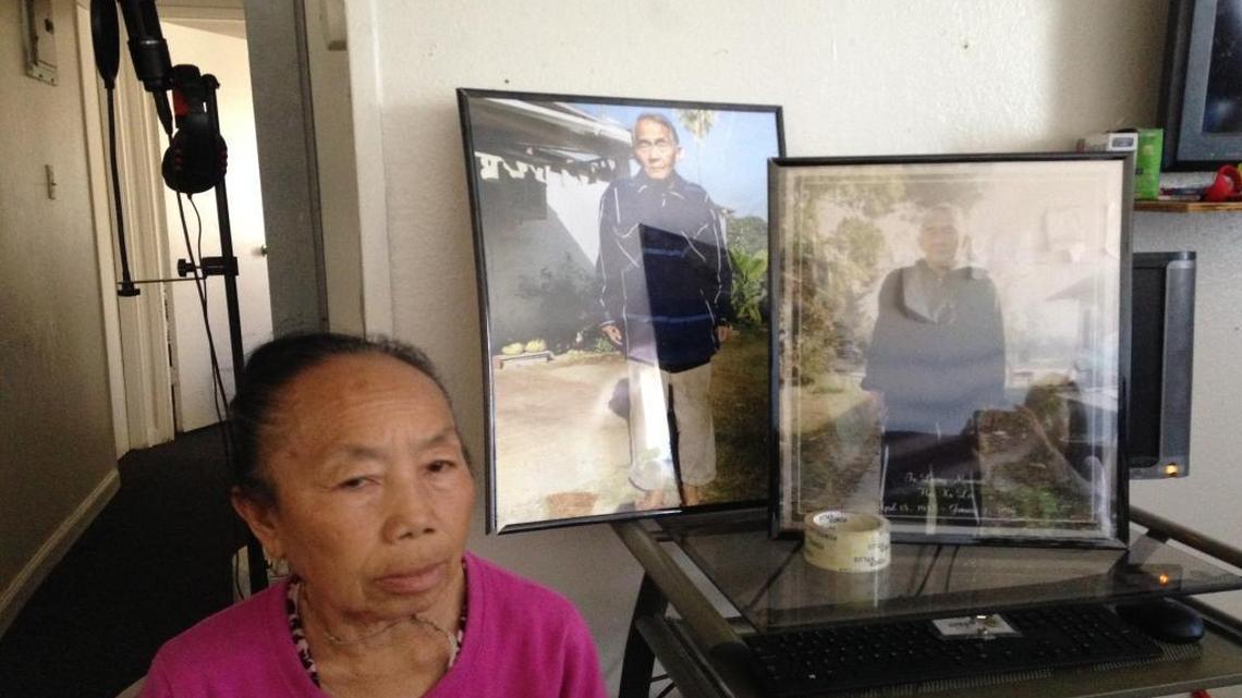 Tong Cha, widow of Her Xa Lor, inside her Summerset Village apartment in central Fresno. Cha is suing the apartment owner for her husband’s death. Behind her are pictures of Lor. She says her husband came down with pneumonia during the month the apartment complex was without heat.