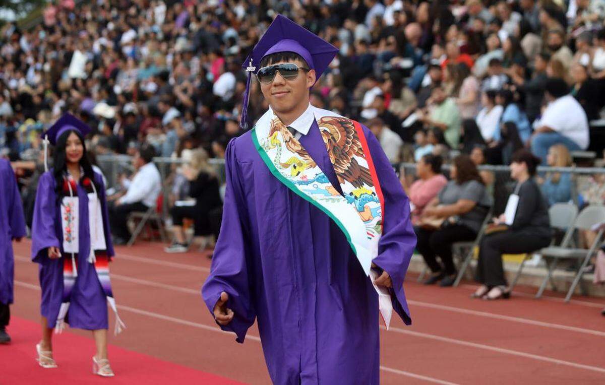 A Madera South High graduate walks to his seat during the graduation ceremony at Madera Memorial Stadium on June 7, 2023.