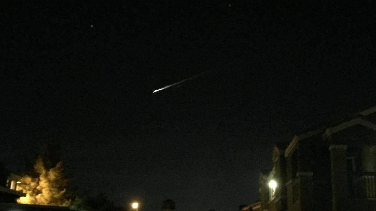 A streak of light is seen over an apartment complex in Las Vegas on Tuesday, Dec. 22, 2015. U.S. military officials say the streak of light seen burning across the sky by people in three Western states was debris from a Russian rocket re-entering the atmosphere. (Gunnar Lindstrom via AP)