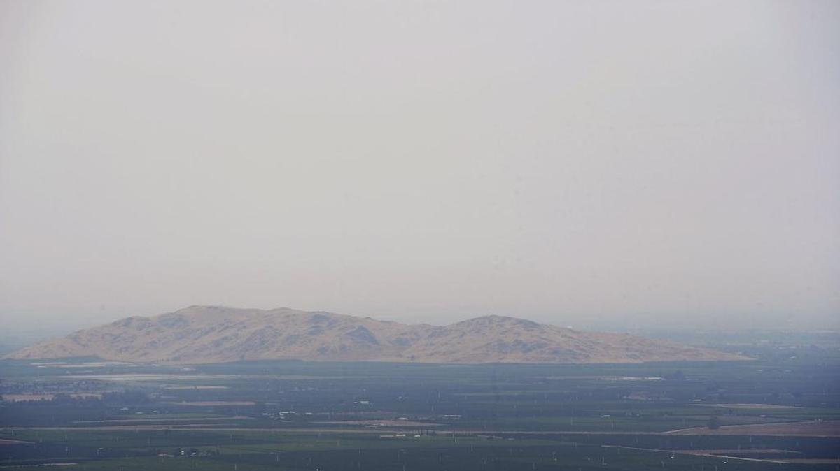 Smith Mountain east of Reedley can be seen through the haze over the valley from a point at Highways 180 and 63 Sunday, July 9, 2017.
