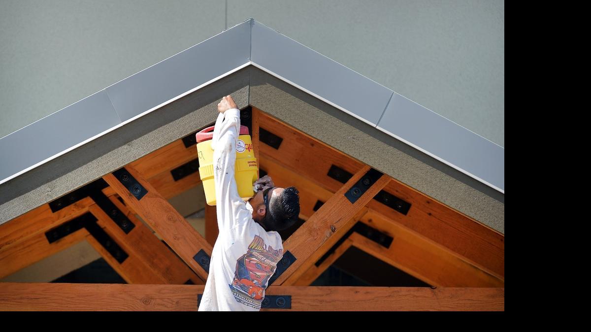 
Michael Rapisura keeps hydrated while painting the beams under the hot afternoon sun at the Falls Event Center in northwest Fresno, California on July 28, 2015. A heatwave is predicted to hit the central San Joaquin Valley this week.
