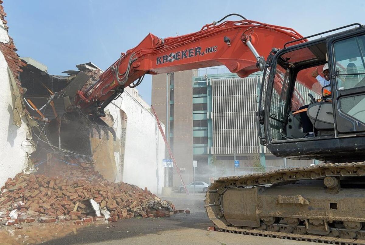 Developer Terance Frazier gives a thumbs up after taking a turn at using an excavator to help with the demolition of two buildings on Fulton Street on Thursday, Feb. 1, 2018. The buildings are being cleared away to make way for the new South Stadium project behind Chukchansi Park, of which Frazier is a partner.