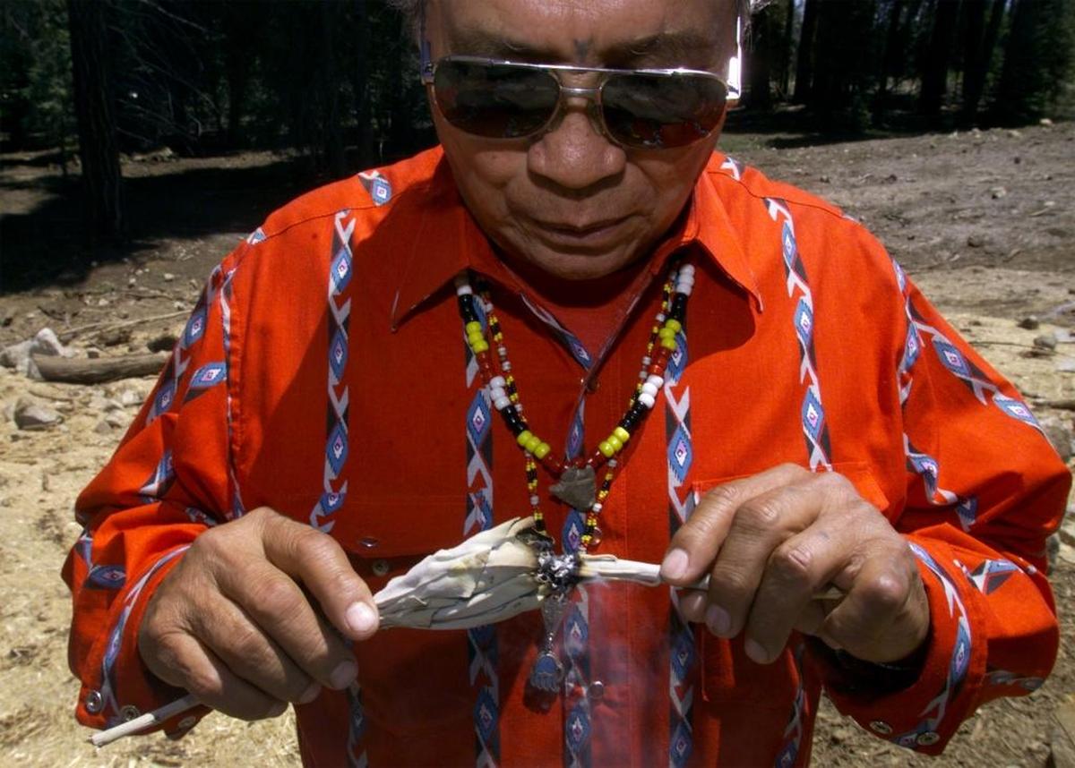 Eddie “Tupishna” Sartuche lights another piece of sage before the opening ceremony for the Wuksachi Lodge in Sequoia National Park on June 10, 1999.