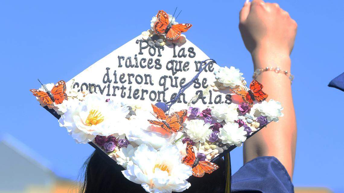 This mortar board seen at the UC Merced commencement on May 15, 2022 reads, “For the roots that you gave me, that turned into wings,” in Spanish. Among undocumented organizers and advocates, monarch butterflies represent migrants’ journey, survival and the power of their community.