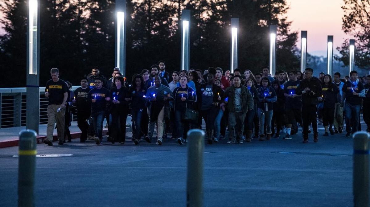 Chancellor Dorothy Leland leads student and staff across the Scholars Lane Bridge during a vigil at the University of California, Merced in Merced, Calif., Friday, Nov. 6, 2015. Students and staff walked from the campus' South Bowl across the bridge toward the Carol Tomlinson-Keasy Quad, in an effort to reclaim the bridge following Wednesday's stabbing spree which left four people wounded and the suspected stabber dead after being shot by the UC Merced police.