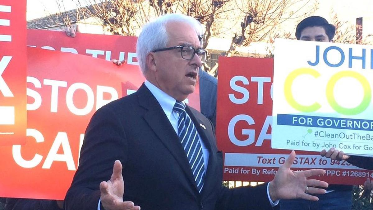 John Cox, a Republican candidate for governor, talks to about a dozen supporters in Fresno at an event Wednesday afternoon to gather signatures to repeal a new state gasoline tax.
