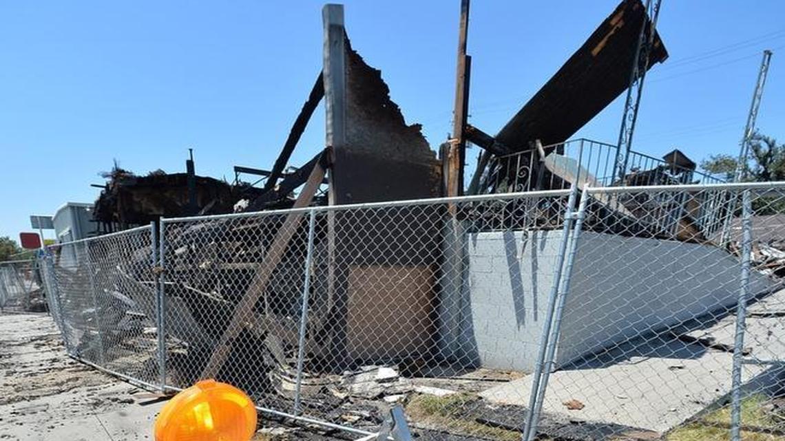 A chain link fence surrounds the outside of an empty commercial building that burned down in the early morning hours of July 5, 2015 at the corner of Grant Avenue and Abby streets in central Fresno. The building had already been damaged by at least one fire before the new fire nearly finished it off. The site was noted by code-enforcement officials as an example of damaged, burned or blighted buildings for which owners were ignoring city orders to either demolish or make repairs.