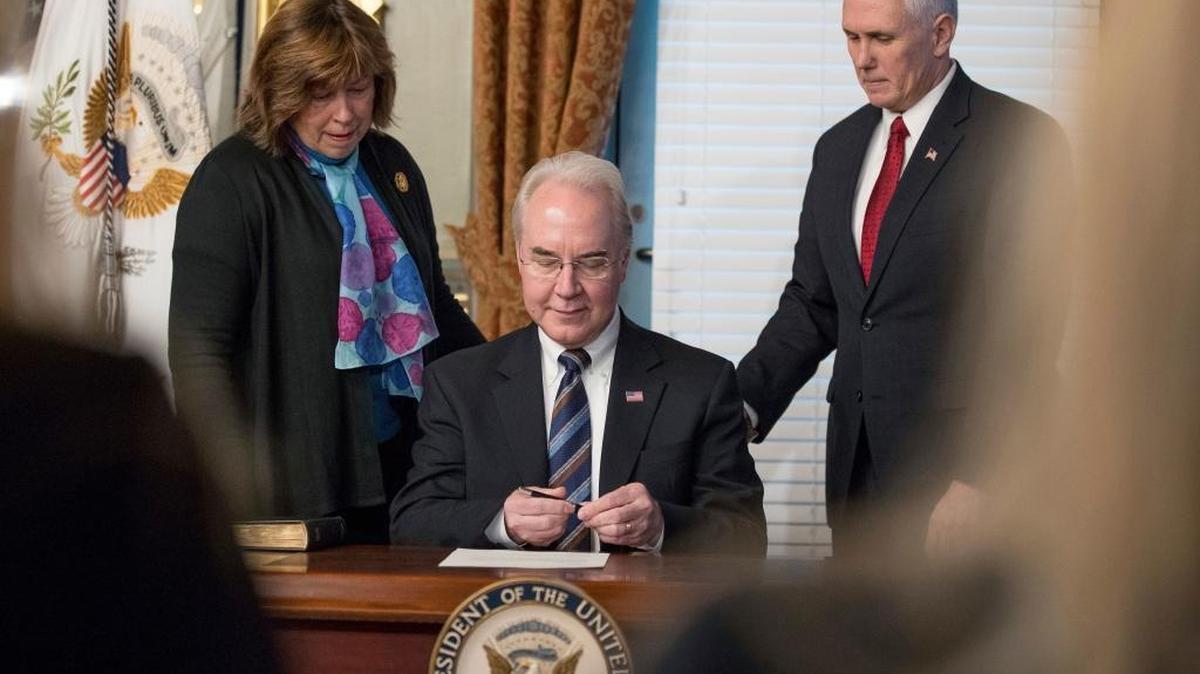 Health and Human Services Secretary Tom Price, center, accompanied by his wife Betty, and Vice President Mike Pence, signs an official document during a swearing-in ceremony, Friday, Feb. 10, 2017, in the in the Eisenhower Executive Office Building on the White House complex in Washington. (AP Photo/Andrew Harnik)