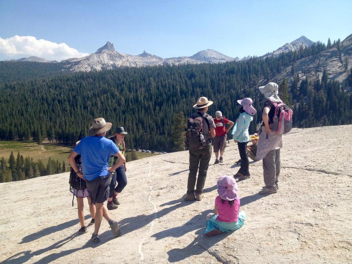 Park ranger Salli Lundgren talks about history and geological features during a junior ranger walk on top of Pothole Dome in Yosemite’s Tuolumne Meadows on Thursday, Aug. 25, 2016.