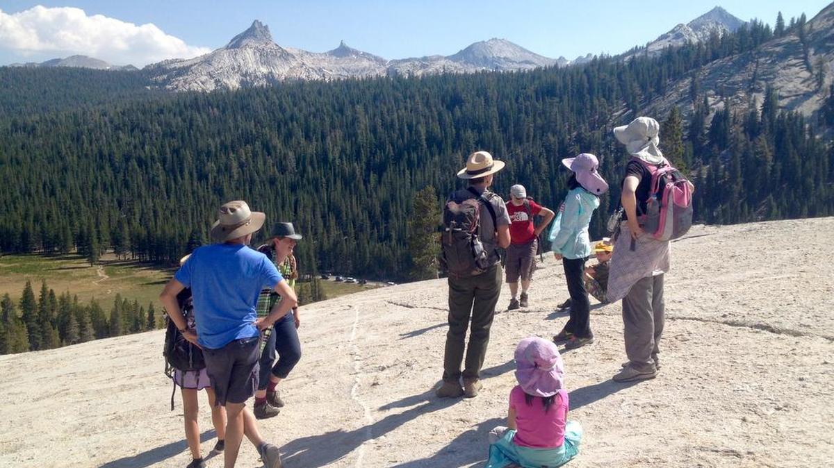 Park ranger Salli Lundgren talks about history and geological features during a junior ranger walk on top of Pothole Dome in Yosemite’s Tuolumne Meadows on Thursday, Aug. 25, 2016.