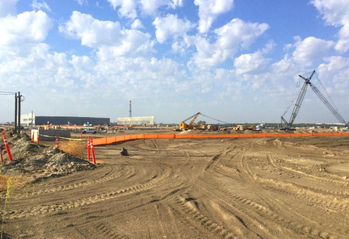 Cranes lift tilt-up concrete walls into position on Tuesday, Sept. 12, at Amazon’s new order-filling center under construction on Orange Avenue between North and Central avenues in south Fresno.