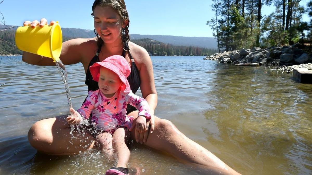 Penelope Werner, 2 plays with family friend Shannan Andersen on the south shore of Bass Lake on Thursday, Sept. 1, 2016. Shannan and Penelope’s family are from Orange County.