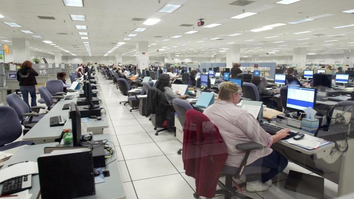 In an April 2007 file photo, employees enter tax returns at the Internal Revenue processing Center in Fresno. The IRS said the it will discontinue its return-processing operations there following the 2021 tax-filing season.