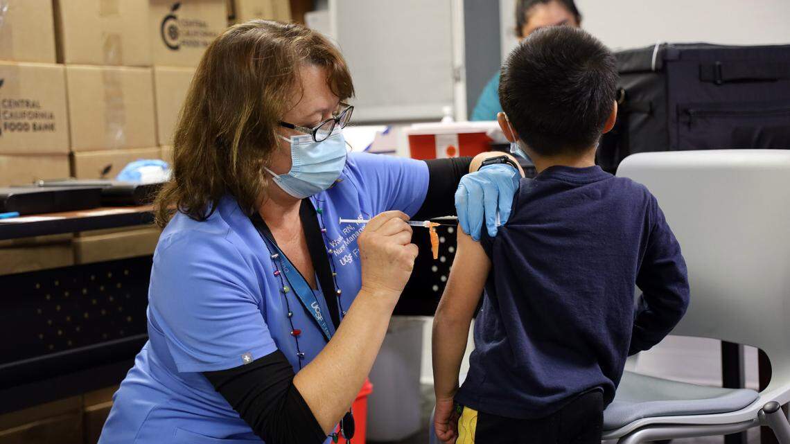 A nurse vaccinates a child during a Dec. 17 COVID-19 vaccination clinic in Fresno.