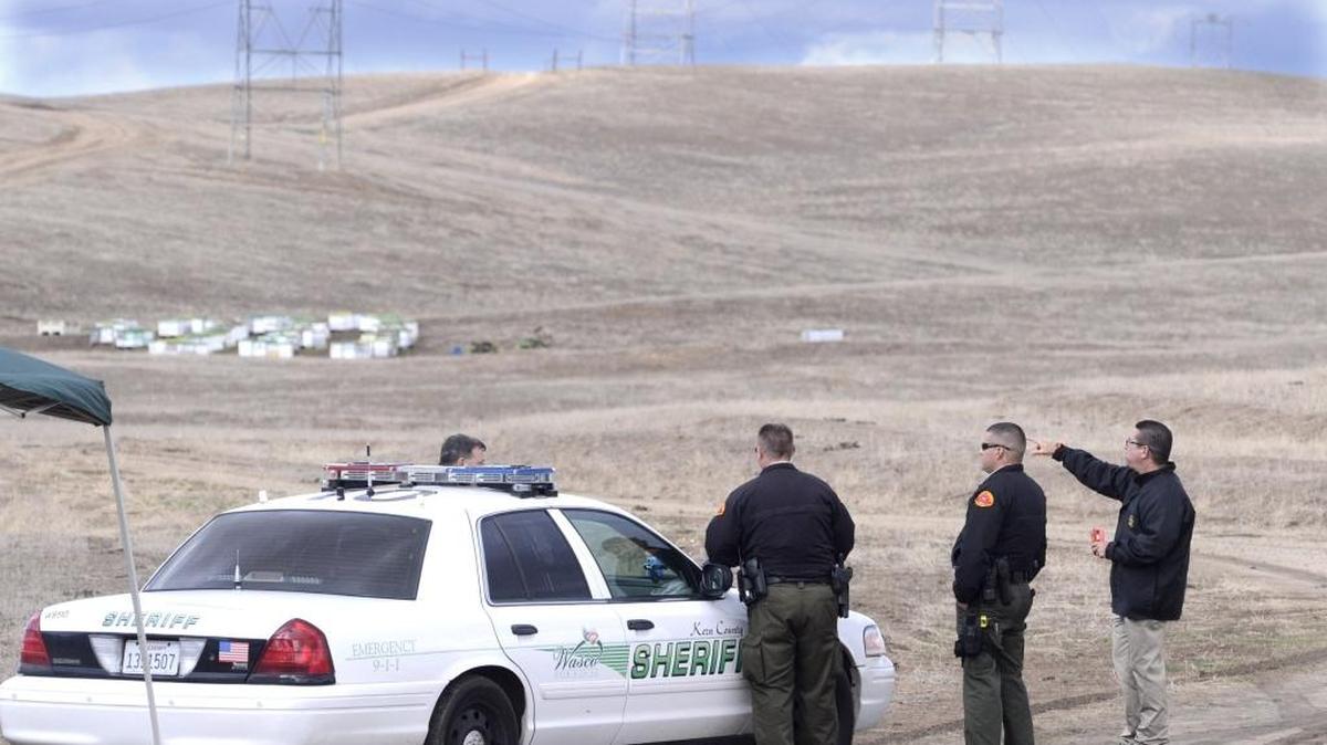 Kern County Sheriff’s deputies at the command center on Sherwood Road, a couple miles from the crash site, on Friday, Dec. 11, 2015.