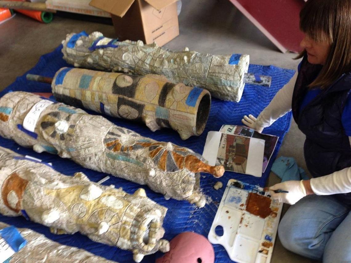 An art restorer works to clean and touch up pieces of Stanley C. Bitters’ artwork “Pipes” from the Fulton Mall. This and other restored art pieces will be reinstalled on Fulton Street when construction of the road is completed.