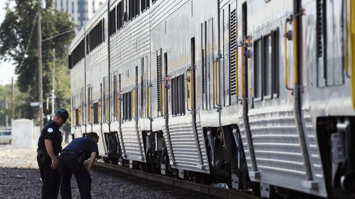 Police officers check the tracks below a stopped Amtrak train near Belmont Avenue and North Diana Street in central Fresno after a fatality Friday afternoon, July 29, 2016. Unconfirmed reports say a man in his late 40s, who was possibly recently released from a hospital, was struck and killed by the Amtrak train Friday afternoon.