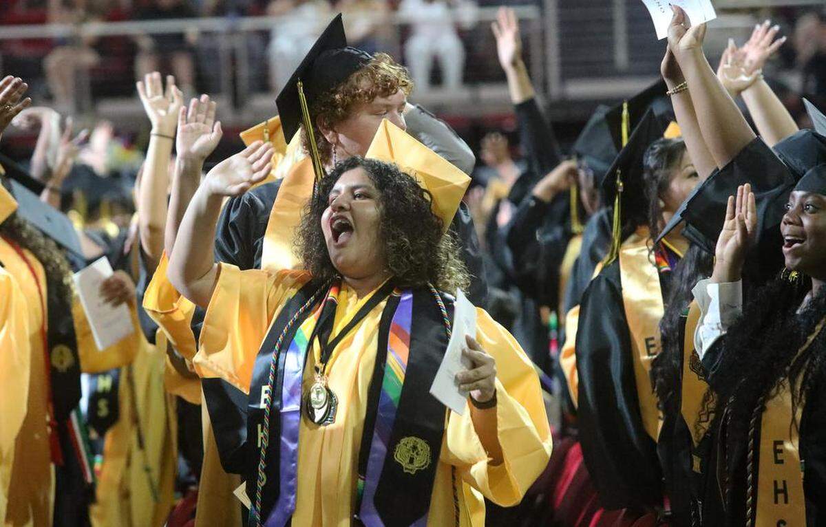 A graduate celebrates with fellow students at the Edison High graduation ceremony at the Save Mart Center on June 5, 2023.