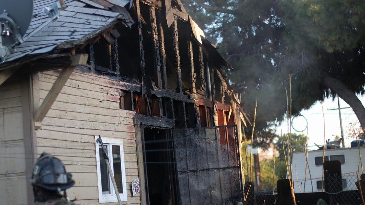 A 58-year-old woman suffered a severe burn on her right hand trying to put a fire that caused a major damage to a home in west Fresno, California on Sunday, Dec. 17, 2017.