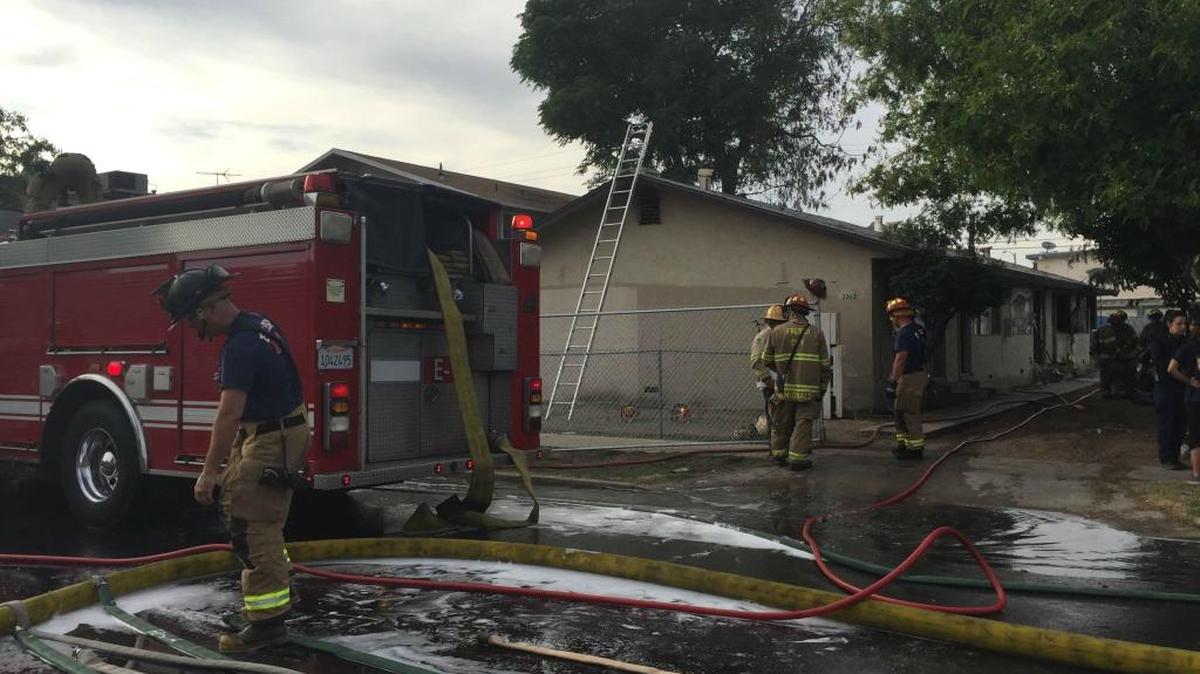 Fresno fire crews work to mop up a two-alarm fire at a central Fresno apartment complex on Tuesday, May 3, 2016.