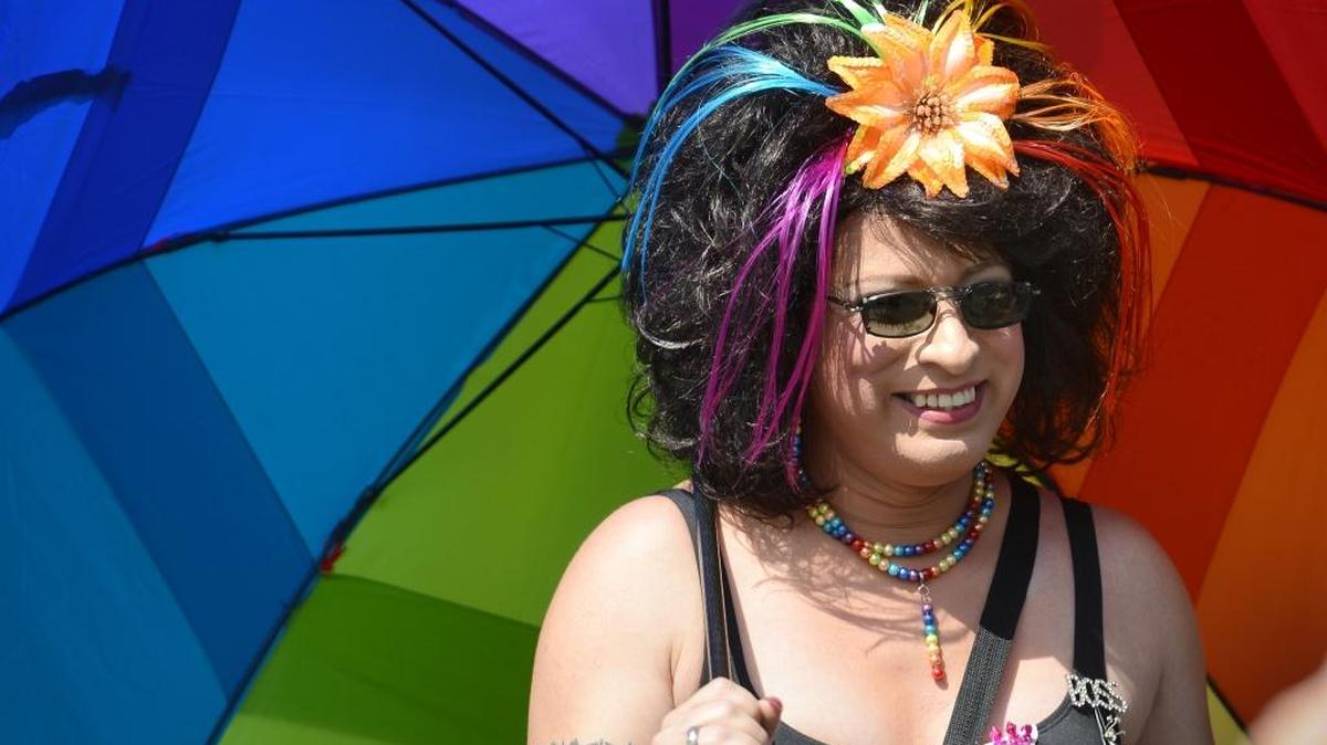 Rocio Delarosa, also known as Leon Velasco, carries a rainbow umbrella while walking with members of Fresno Trans-E-Motion during the 2013 Rainbow Pride Parade and festival in Fresno’s Tower District. Trans-E-Motion is organizing a number of Transgender Day of Visibility events in Fresno.