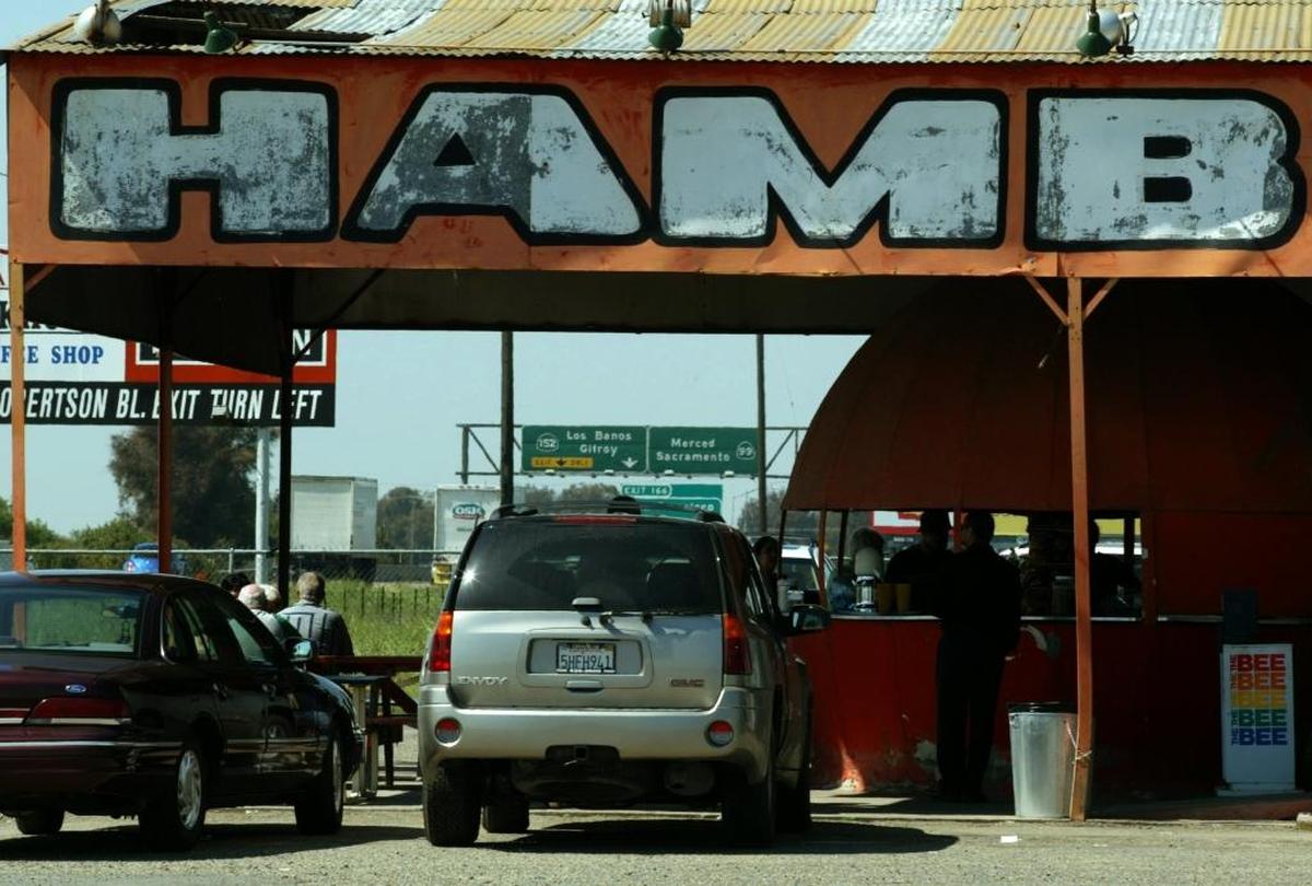 Customers gather at the Mammoth Orange food stand along highway 99 north of Madera on March 31, 2005.