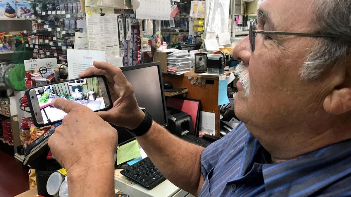 Steve Valdez, a clerk at Coast Hardware in Mariposa, shows a video he made of his property to submit to insurance companies when he knew his home was going to be destroyed by the Detwiler Fire. “We’ll plan to rebuild, I suppose,” Valdez said. “I mean, that’s all we can really do.”