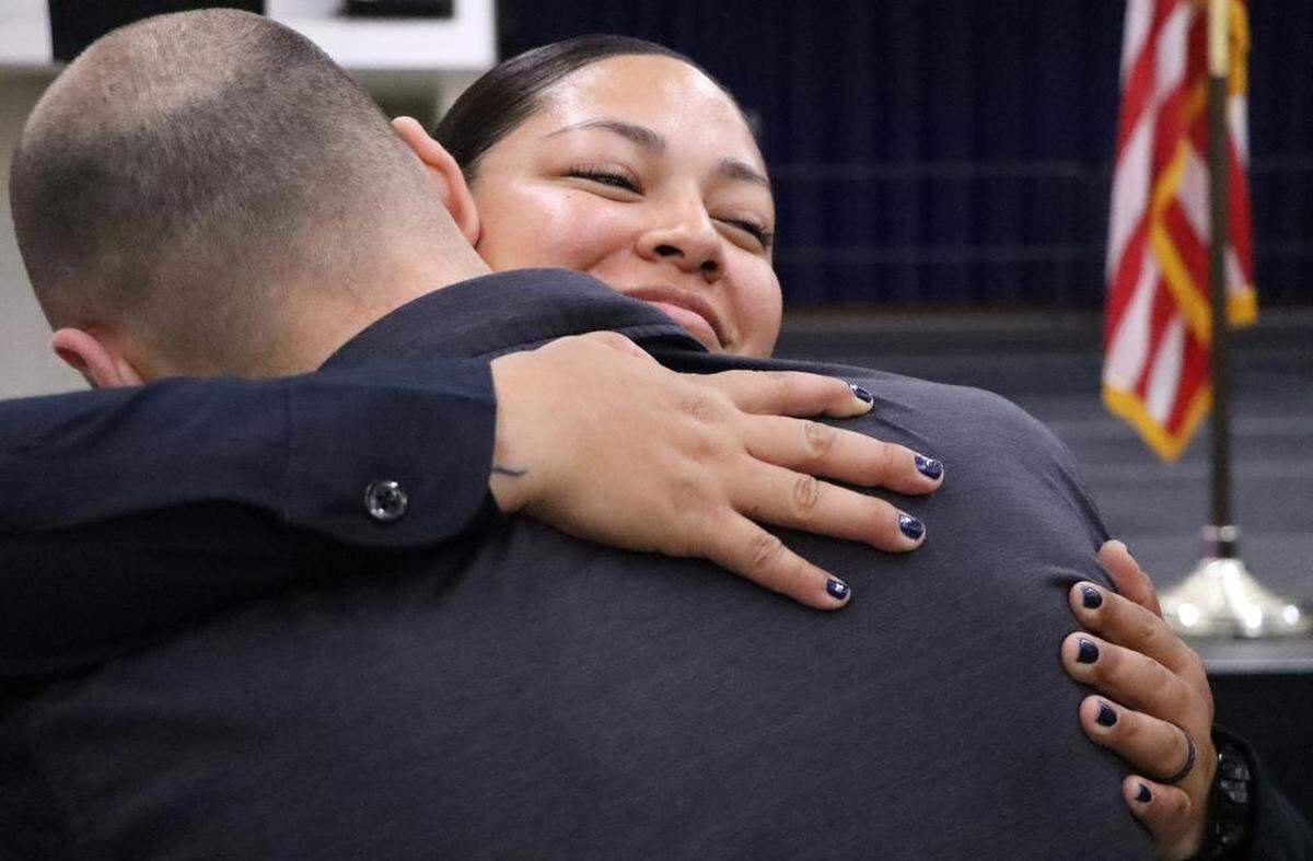New Fresno Police Officer Linda Ramos gets a hug from husband Kyle Blackburn after being sworn in during Sept. 1, 2023 ceremony at the Fresno Convention Center.
