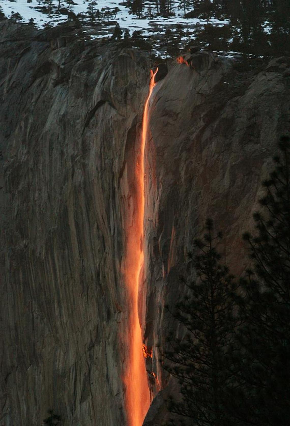 The annual firefall from Horsetail Fall in Yosemite Valley glows after the sun has disappeared below the horizon. 