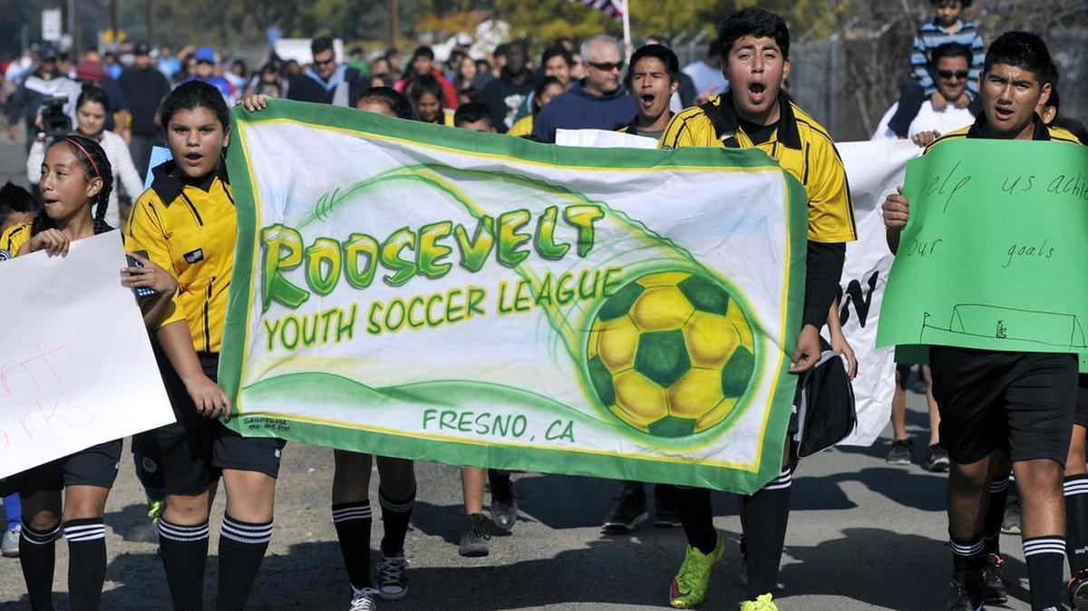 In 2015, members of the Roosevelt Youth Soccer League reach the end of a march with other soccer players, fans and families calling for the City of Fresno to build a soccer park at a 49-acre parcel of land along South Peach Avenue.