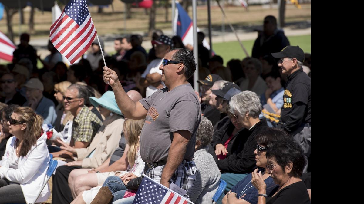 
Navy veteran Danny Quinonez of Fresno waves the flag during the Memorial Day ceremony at San Joaquin Valley National Cemetery in Santa Nella on Sunday.
