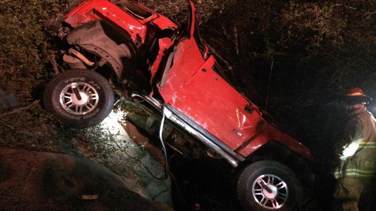 A Hummer H3 rests at the bottom of an embankment off Highway 41 just north of the North Fork turnoff Friday night. The driver of the Hummer was killed and his three passengers injured after their vehicle was rear-ended.