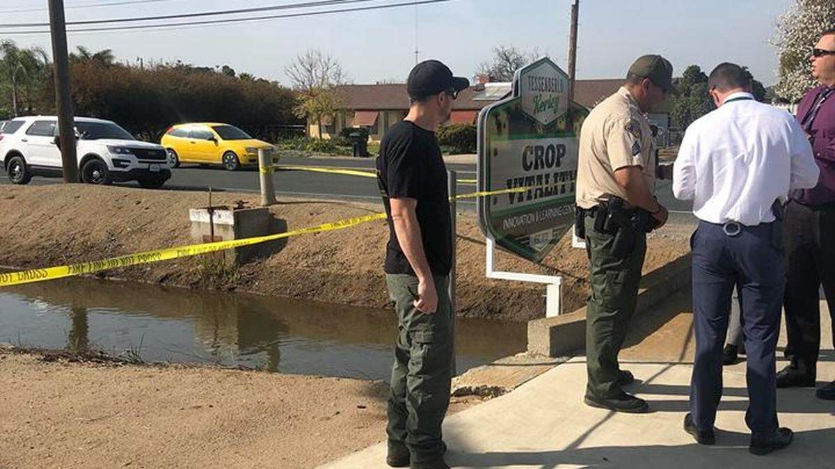Detectives at the scene of where a body was discovered in a canal in Sultana, CA, March 25, 2019.