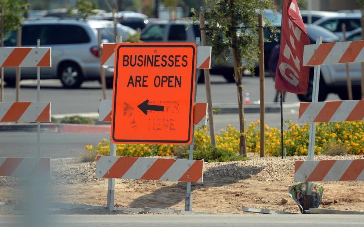 A sign advises that businesses are open in the Clinton and Weber avenues area despite construction all around and the closure of the Clinton and Highway 99 overpass.